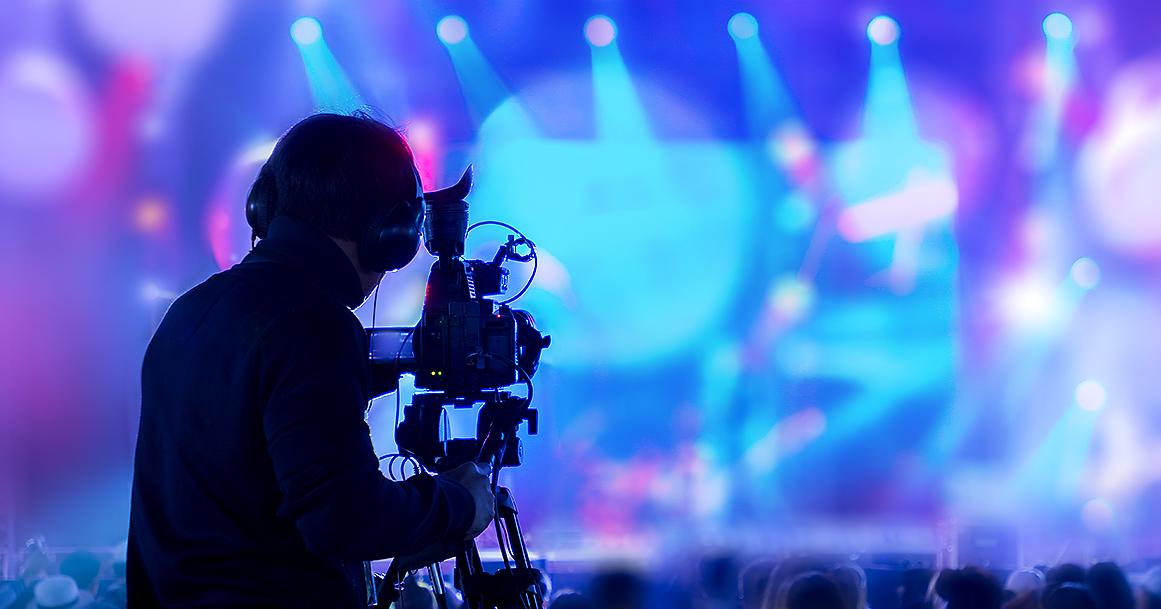 A man filming a consert (Photo: Shutterstock)