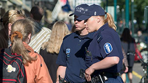 Two police officers patrol a summer event