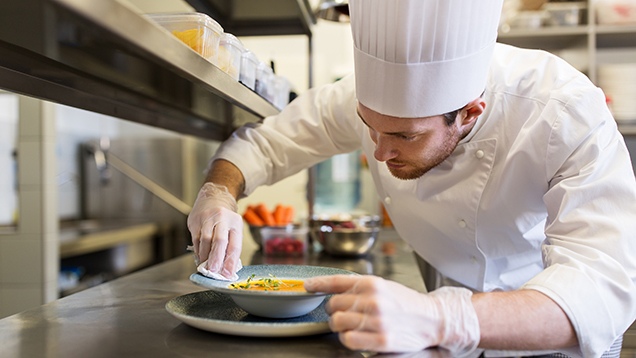 Kokki viimeistelee ruoka-annosta.