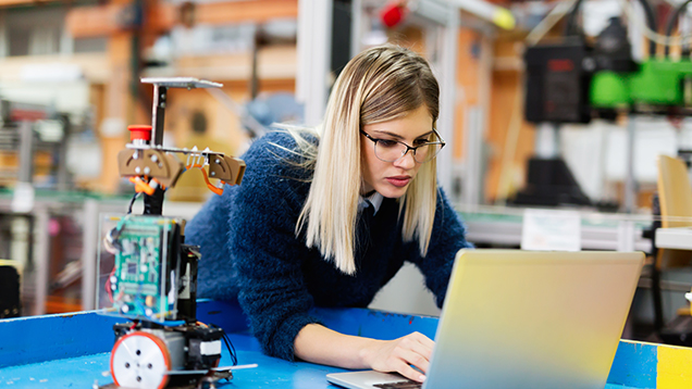 Young woman is working in the technical company.