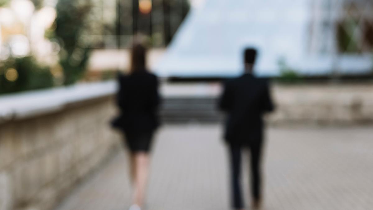 Two persons walking away.