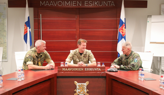 Commanders discussing in the conference room.