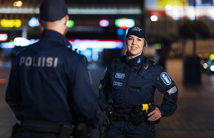 Illustration bild. Två poliser står på en stadsgata på kvällen.