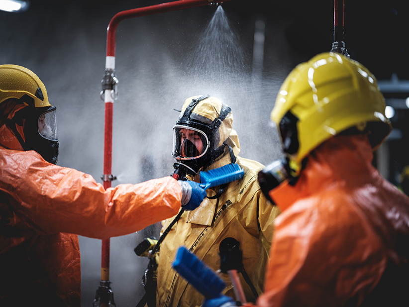 Rescuers wearing protective overalls