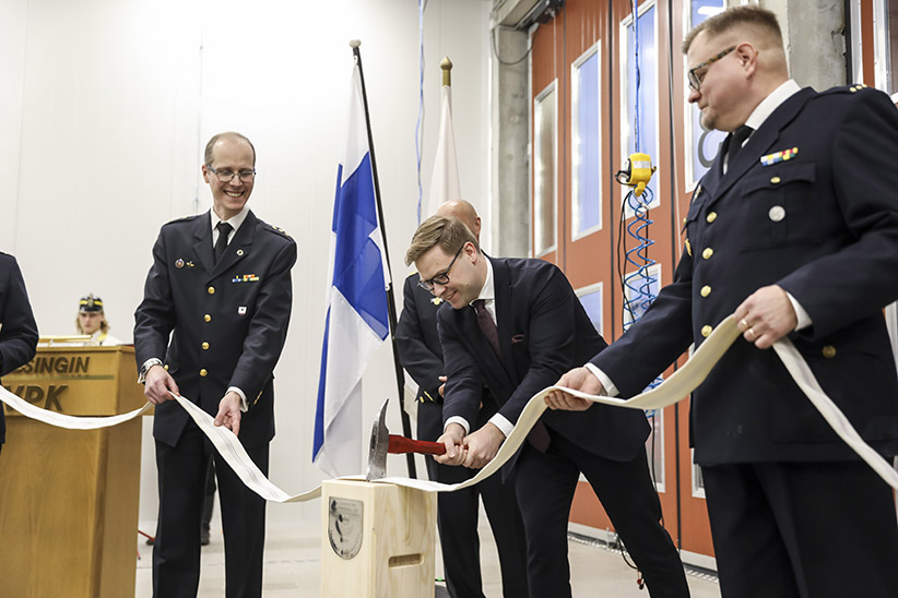 Three men cutting a hose.