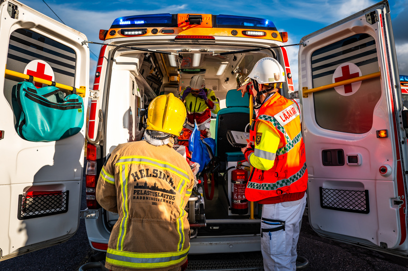 Rescuers at the back door of the ambulance.